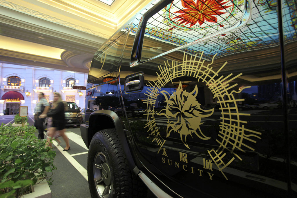A limousine featuring the company logo of Suncity Group is parked outside Macau Galaxy resort in Mac